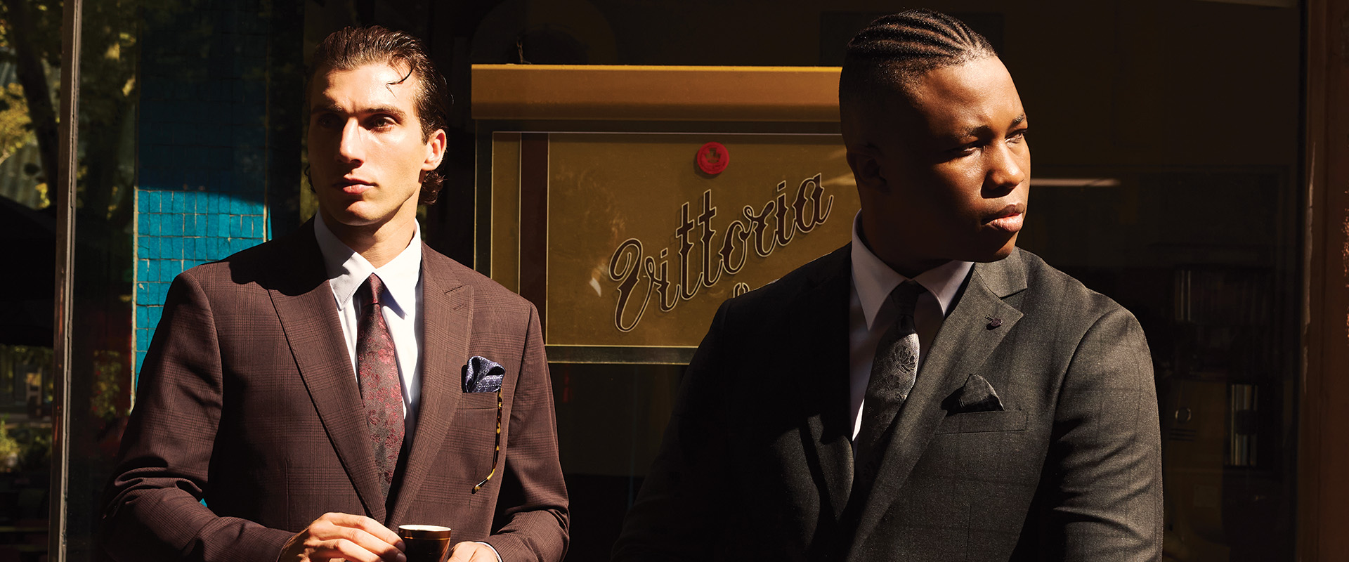Two men in sharp tailored suits from the Politix x Shayne Tino AW25 collection